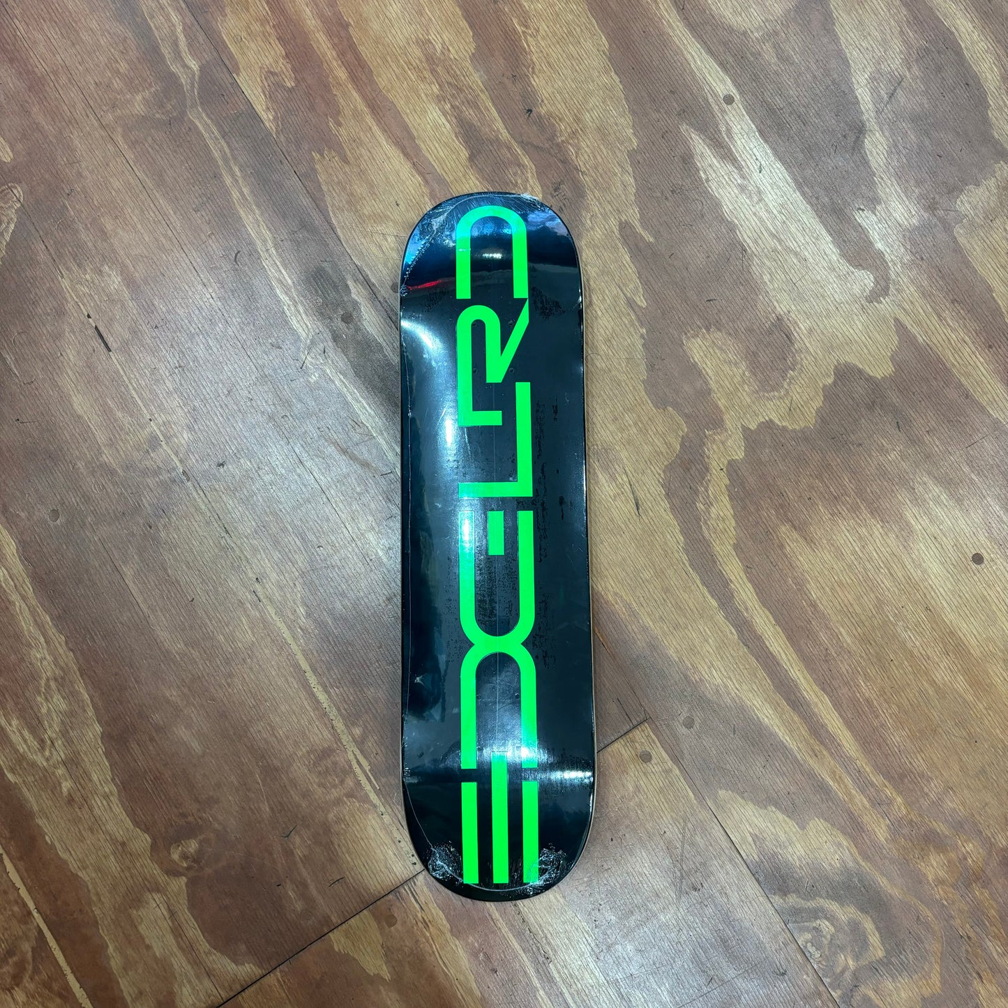 Green EDGLRD logo on black skateboard deck-this is color on the 8.25 size 