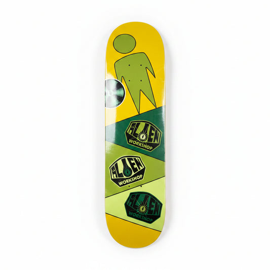 Skateboard deck with green and yellow design on a white surface