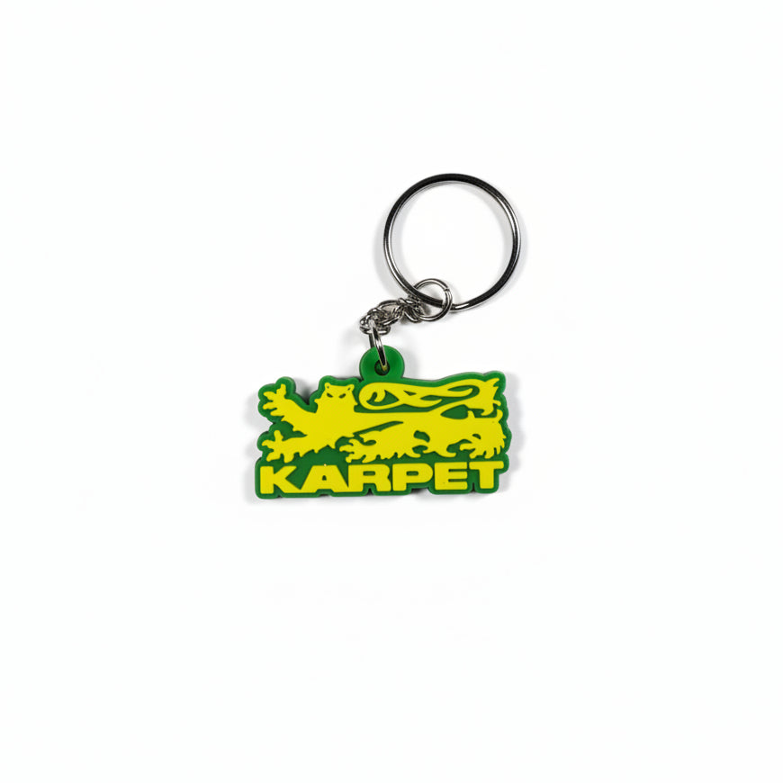 Green keychain with 'Karpet' branding on a white surface