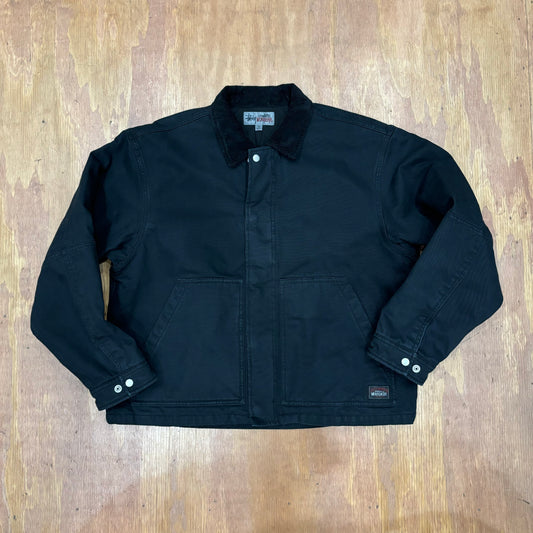 Front view of stussy workgear jacket in black with cordoroy collar