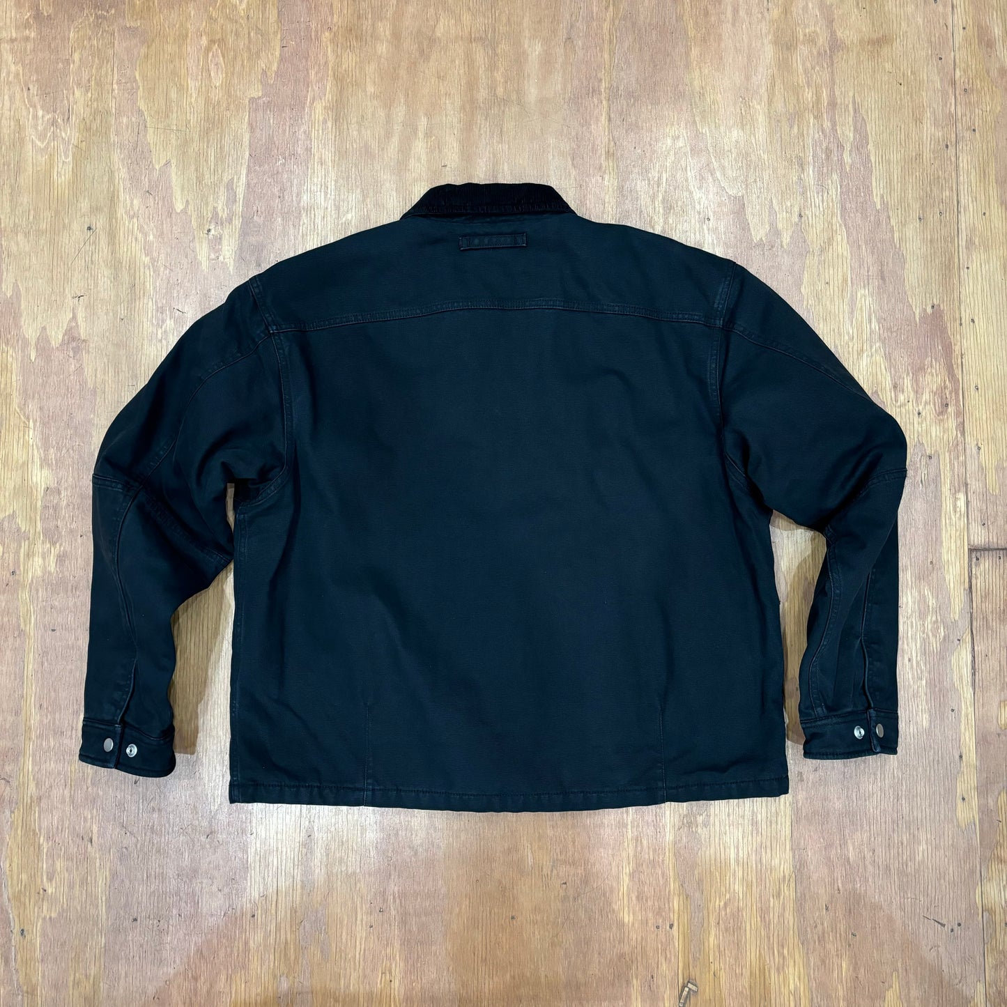 rear view of stussy workgear jacket in black