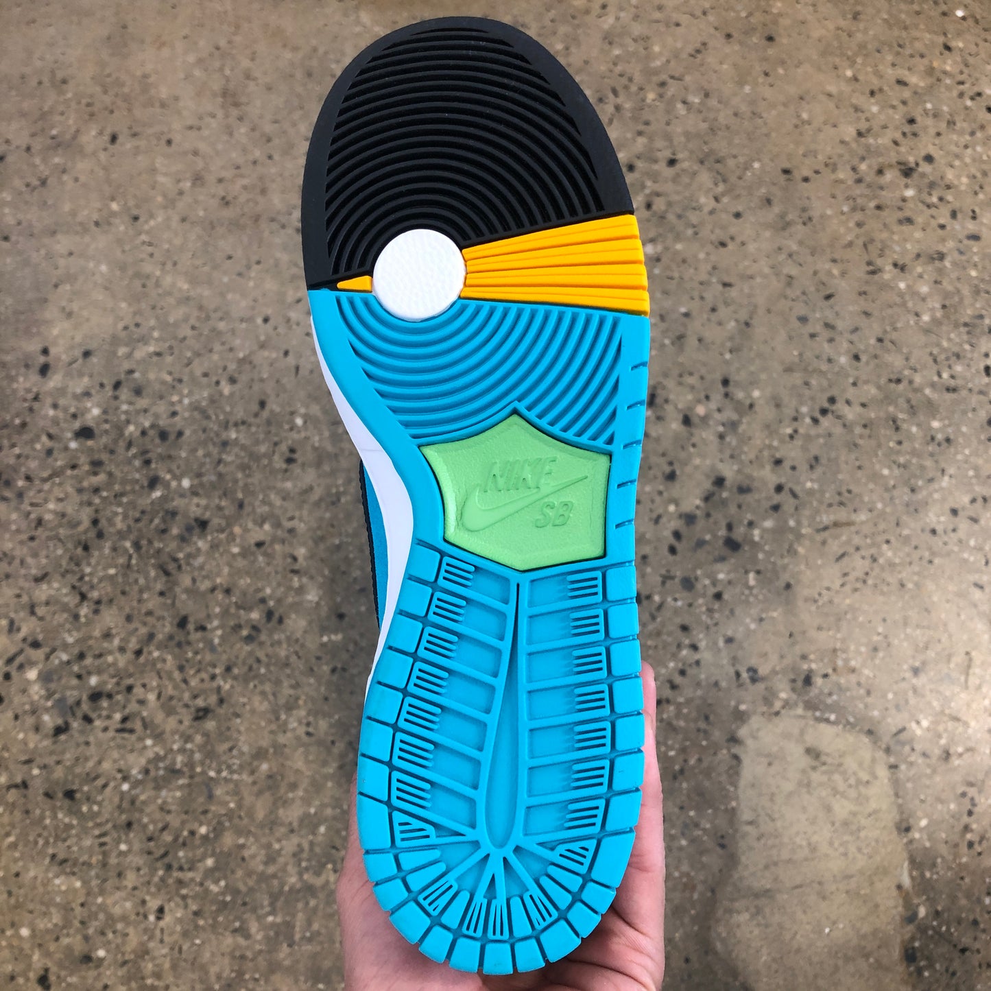 photo of the sole of the shoe, black, yellow, white, and blue coloring 