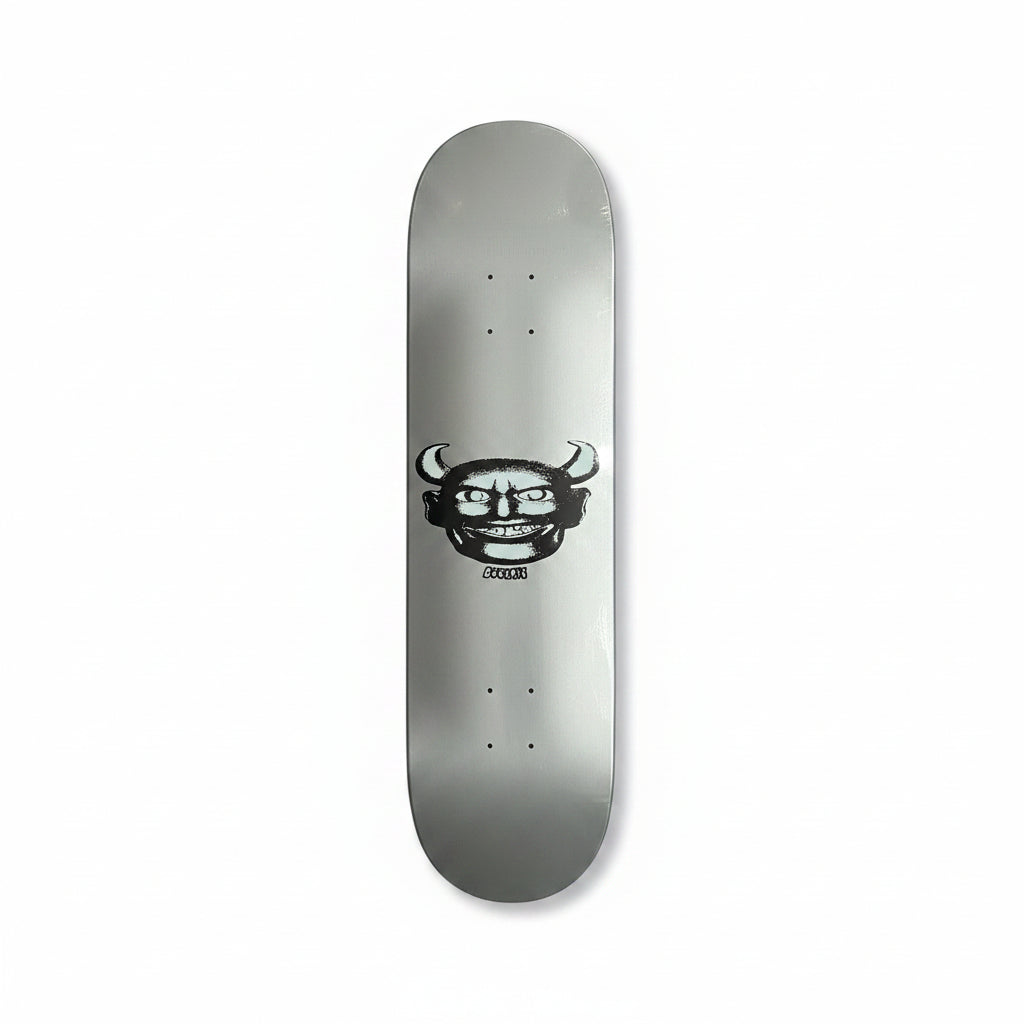 silver skateboard deck with devil man style face graphic on center of deck