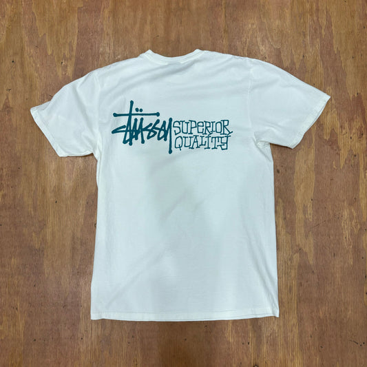 view of rear of t-shirt with stussy logo and superior quality logo