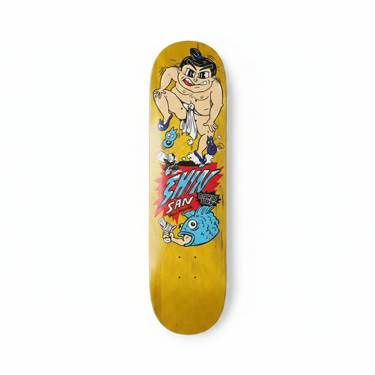 Skateboard deck with cartoon character and 'Shin San' text on a white surface