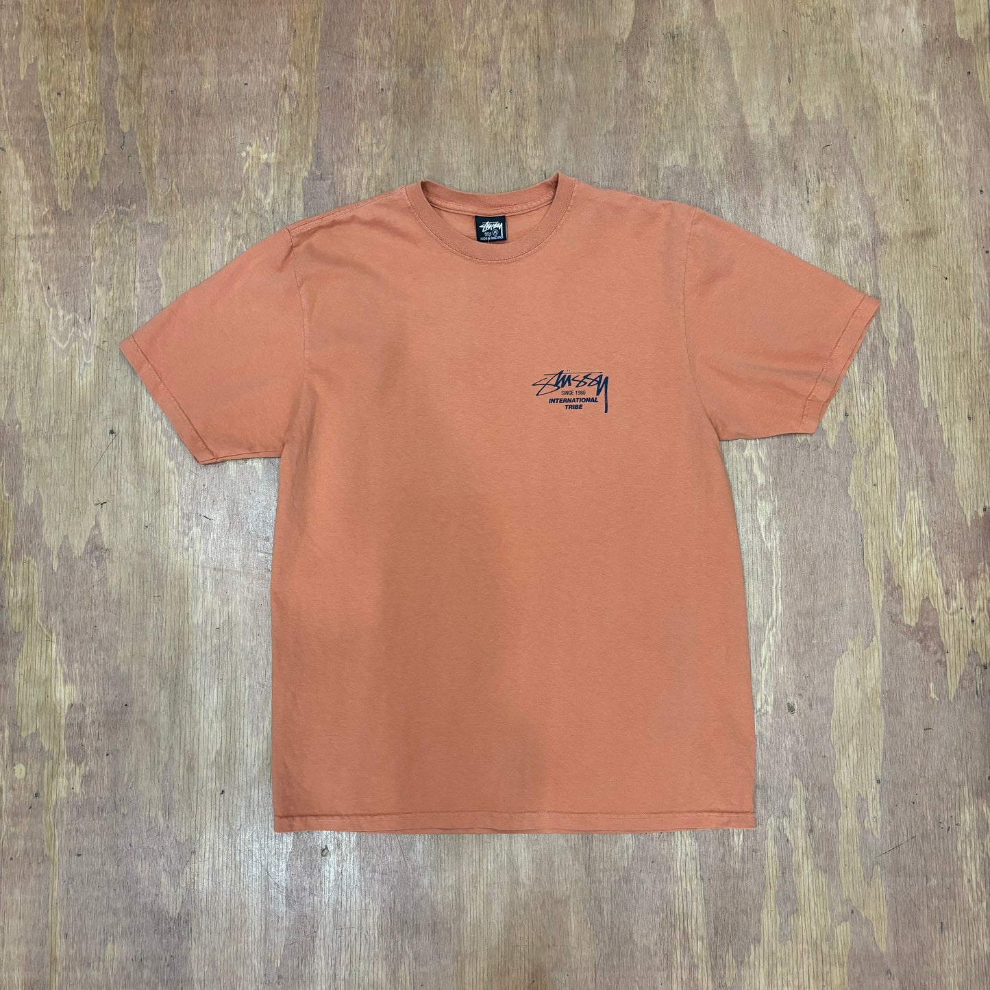 view of front of tee with stussy print on left chest