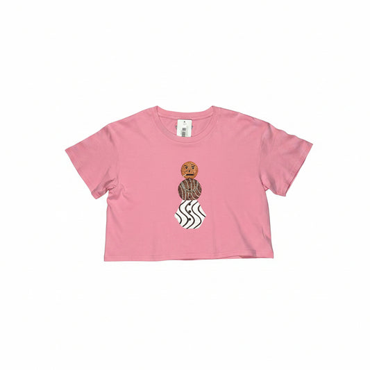Pink crop top t-shirt with a graphic design on a white surface