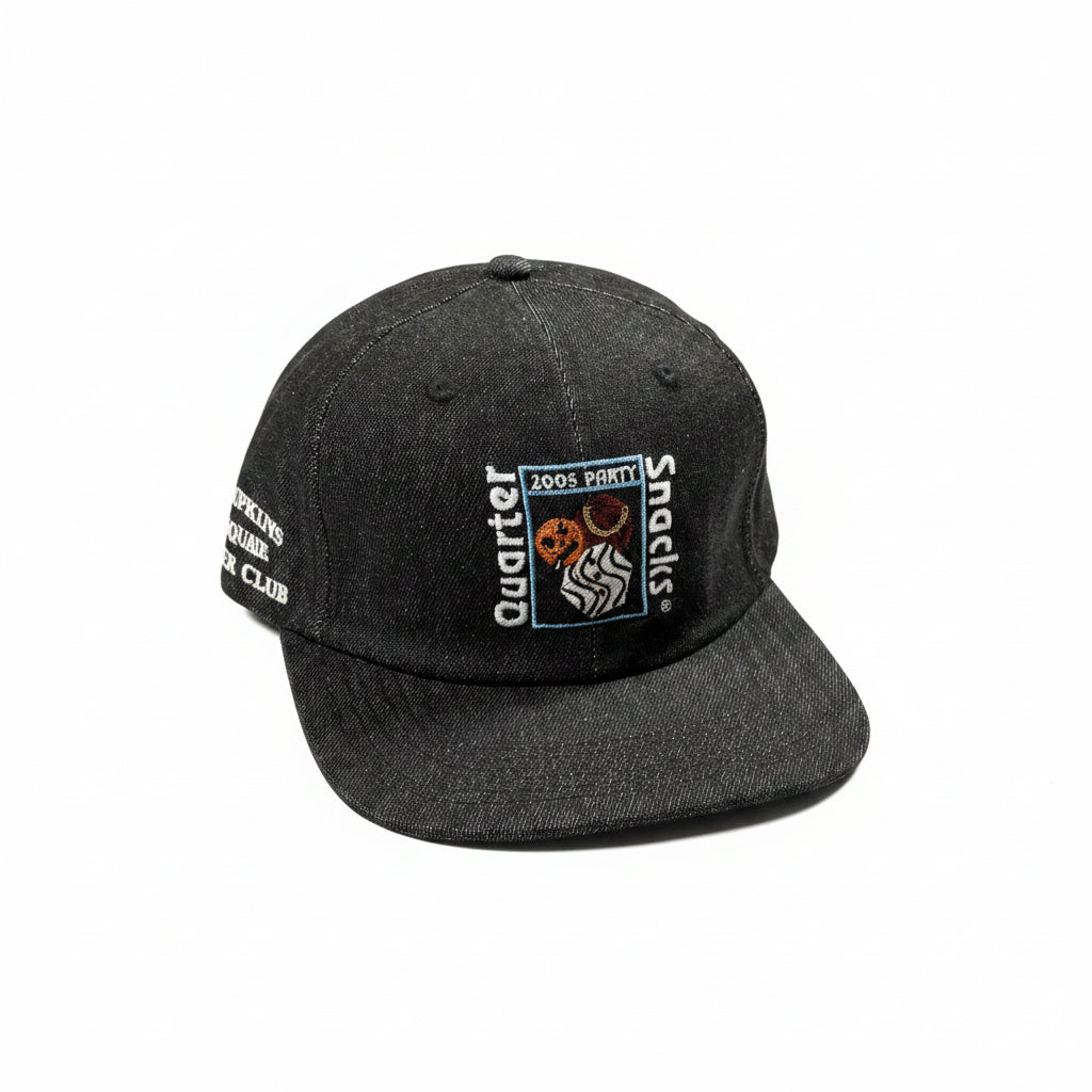 Black cap with embroidered design on a white surface