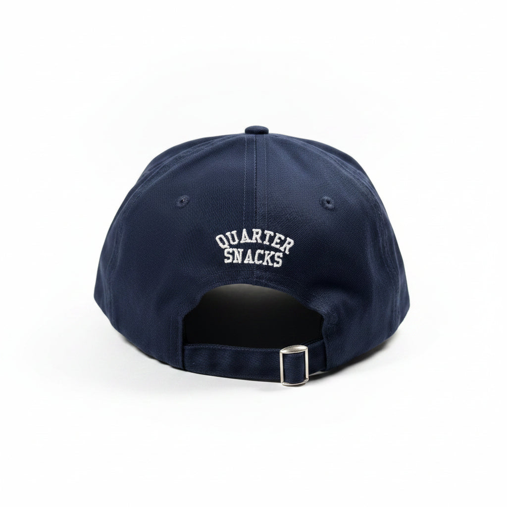 Navy blue cap with 'Quarter Snacks' logo on a white surface
