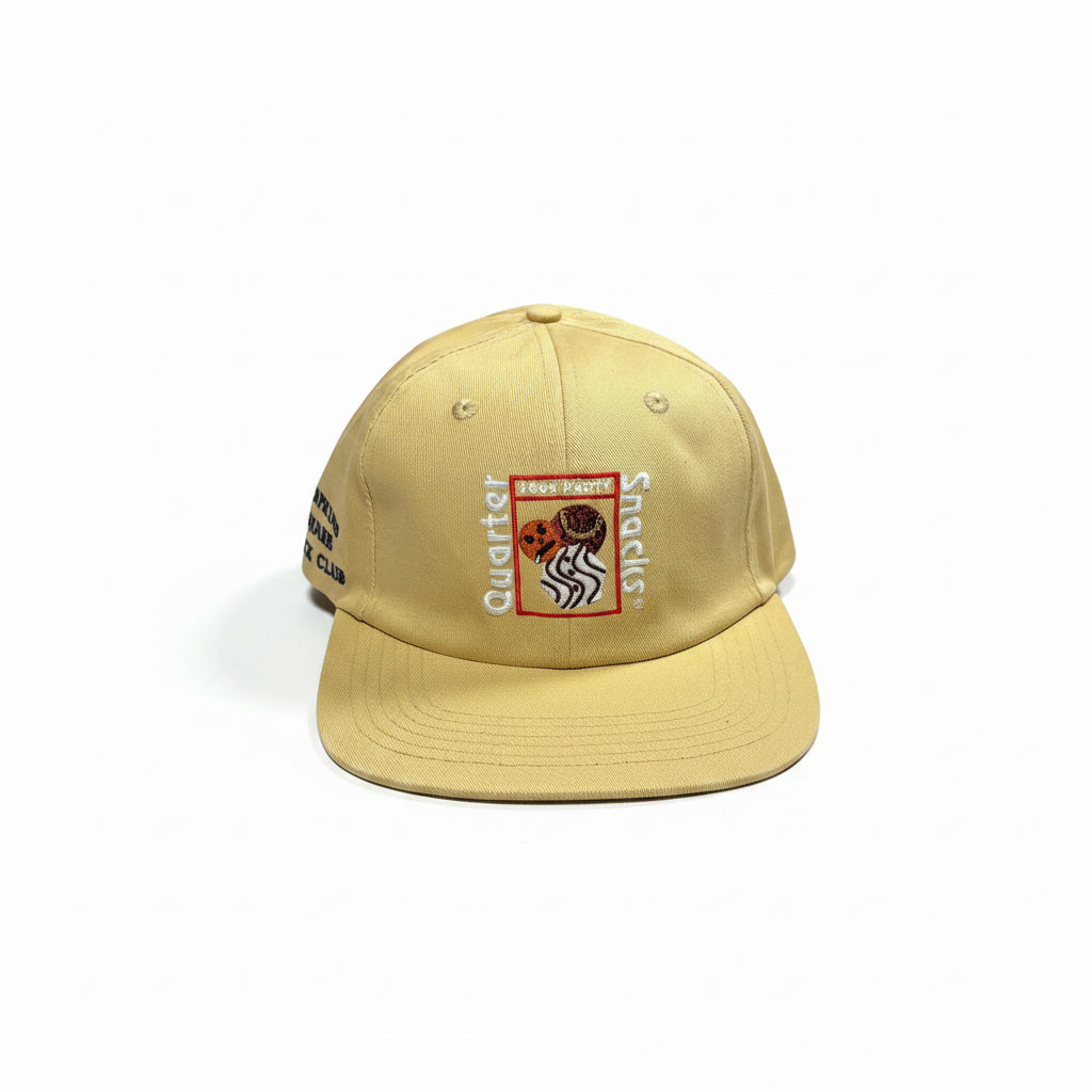 Beige cap with logos on a white surface