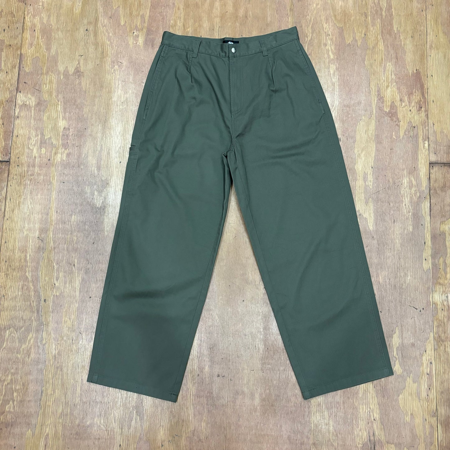 Front view of stussy workgear trouser in olive green