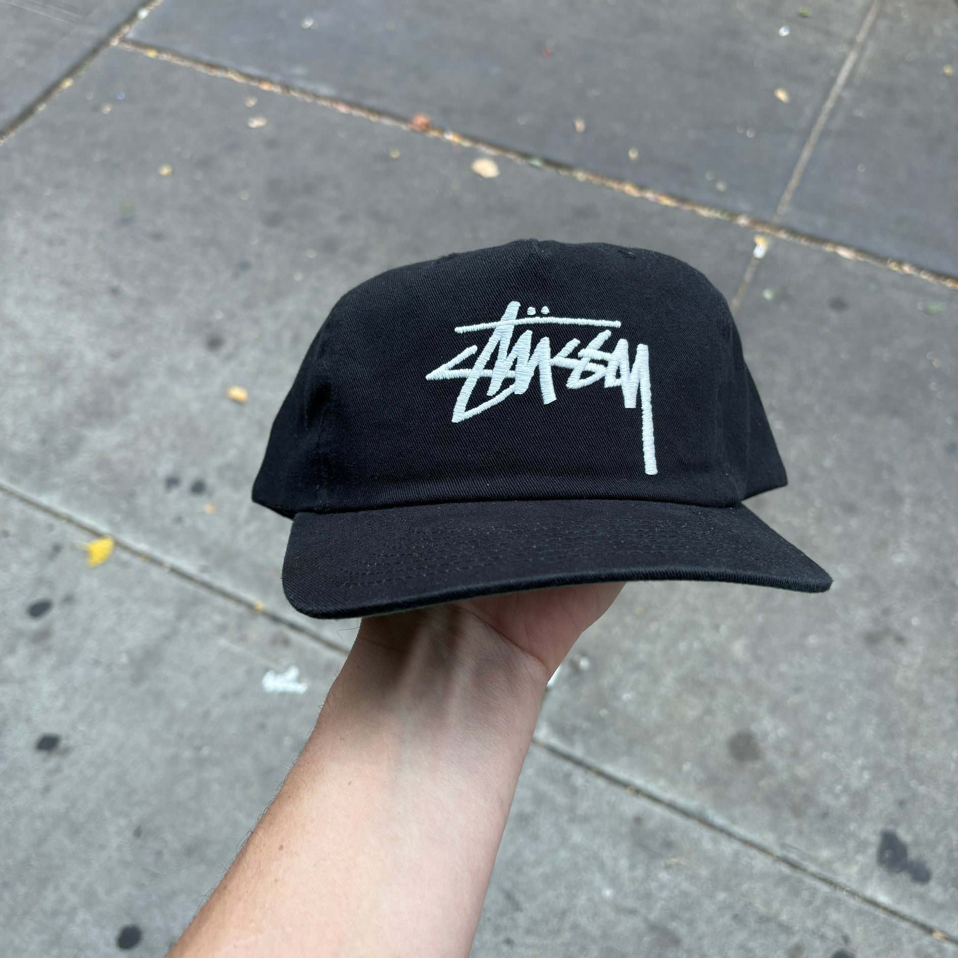 front view of stussy logo snapback cap