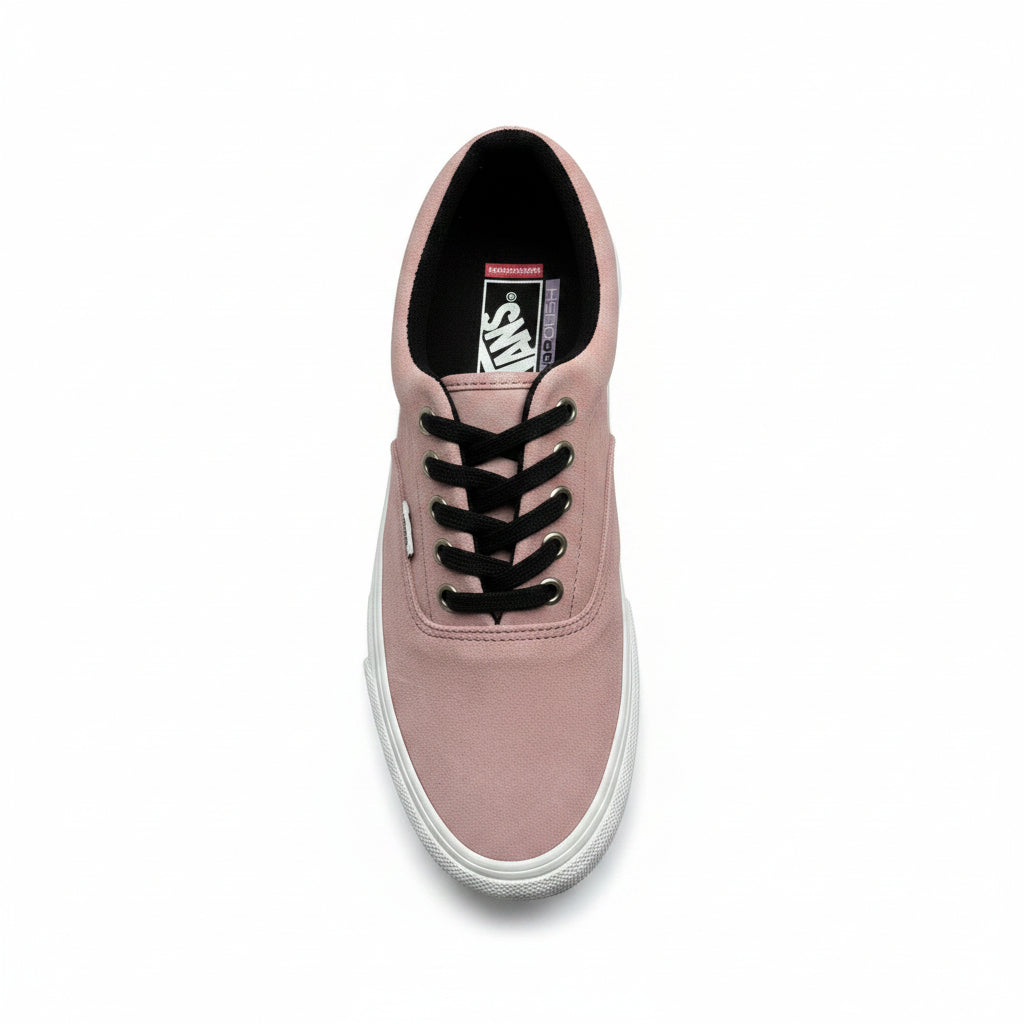 Pink sneaker with black laces on a white background