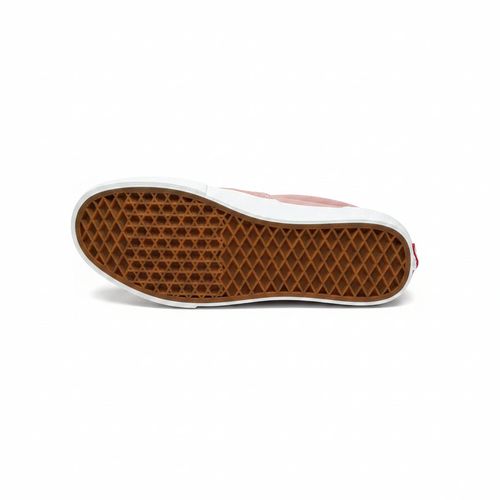 Sole of a shoe with brown waffle pattern on a white surface