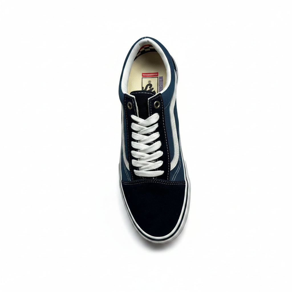 Navy and black sneaker with white laces on a gray concrete background