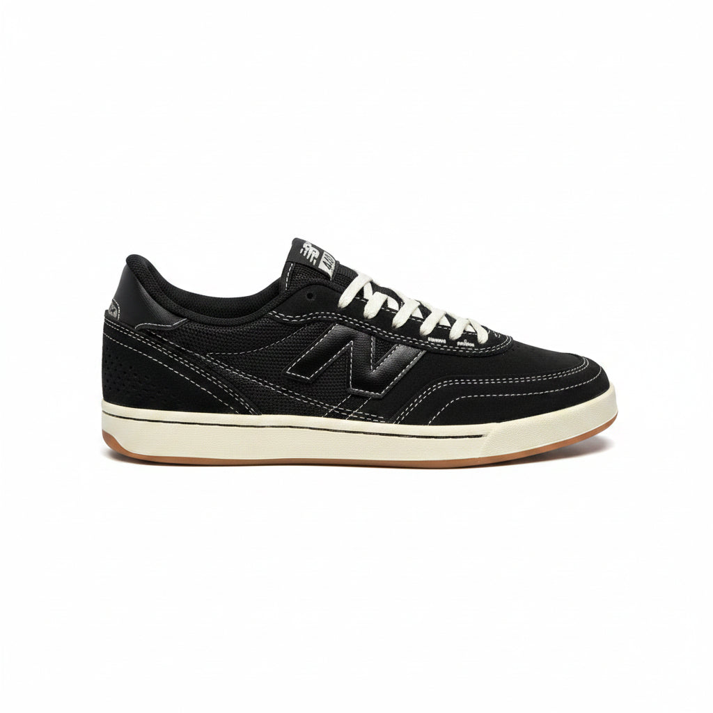 Black sneaker with white laces on a white background