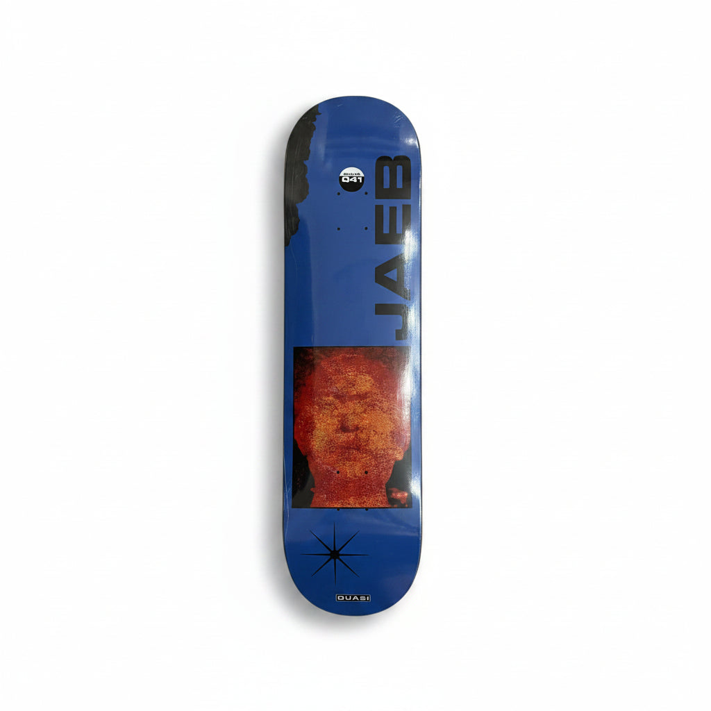 Blue skateboard deck with a face design and 'Jaeb' branding on a white surface.