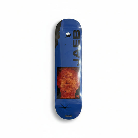 Blue skateboard deck with a face design and 'Jaeb' branding on a white surface.