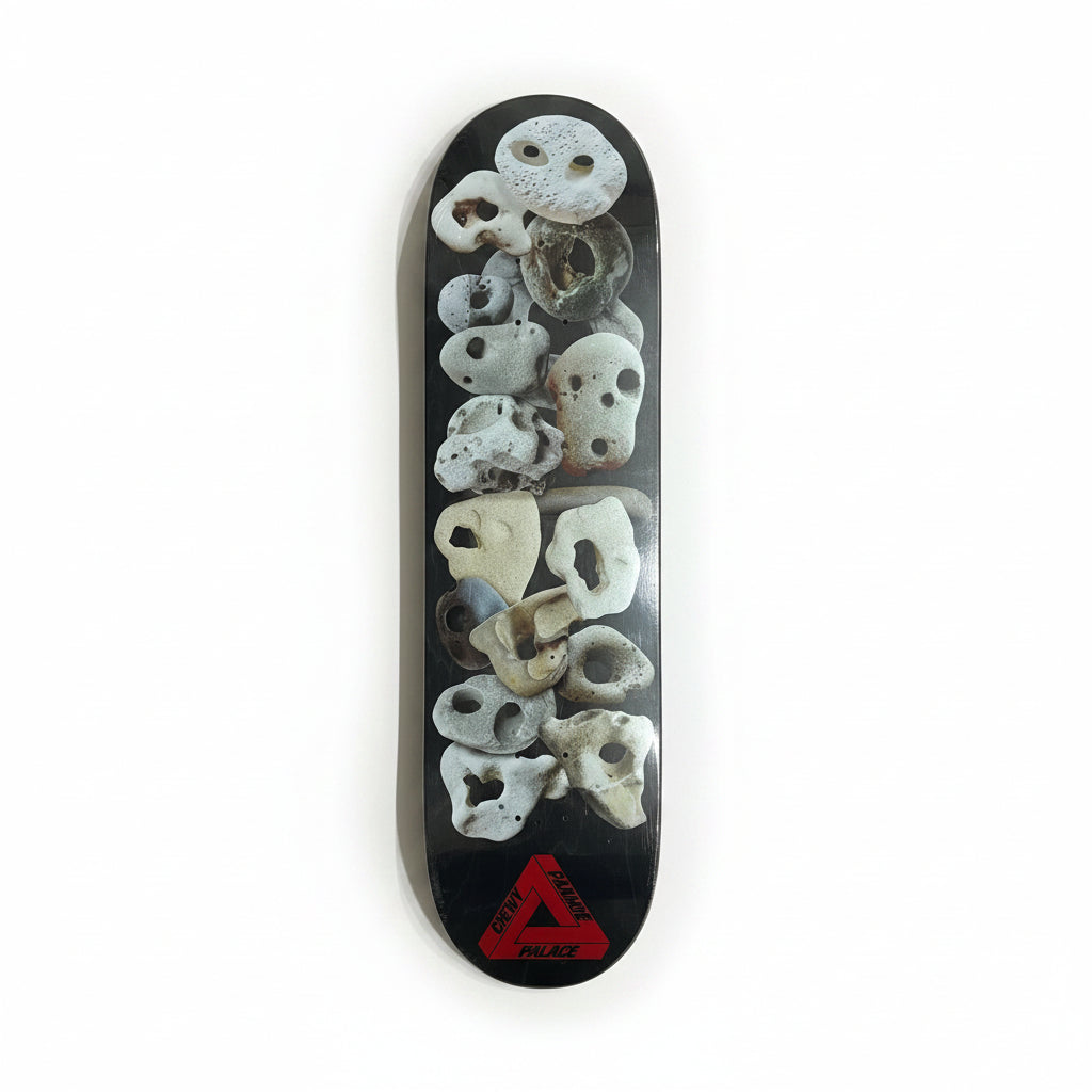 dark colored skateboard deck with rocks with holes