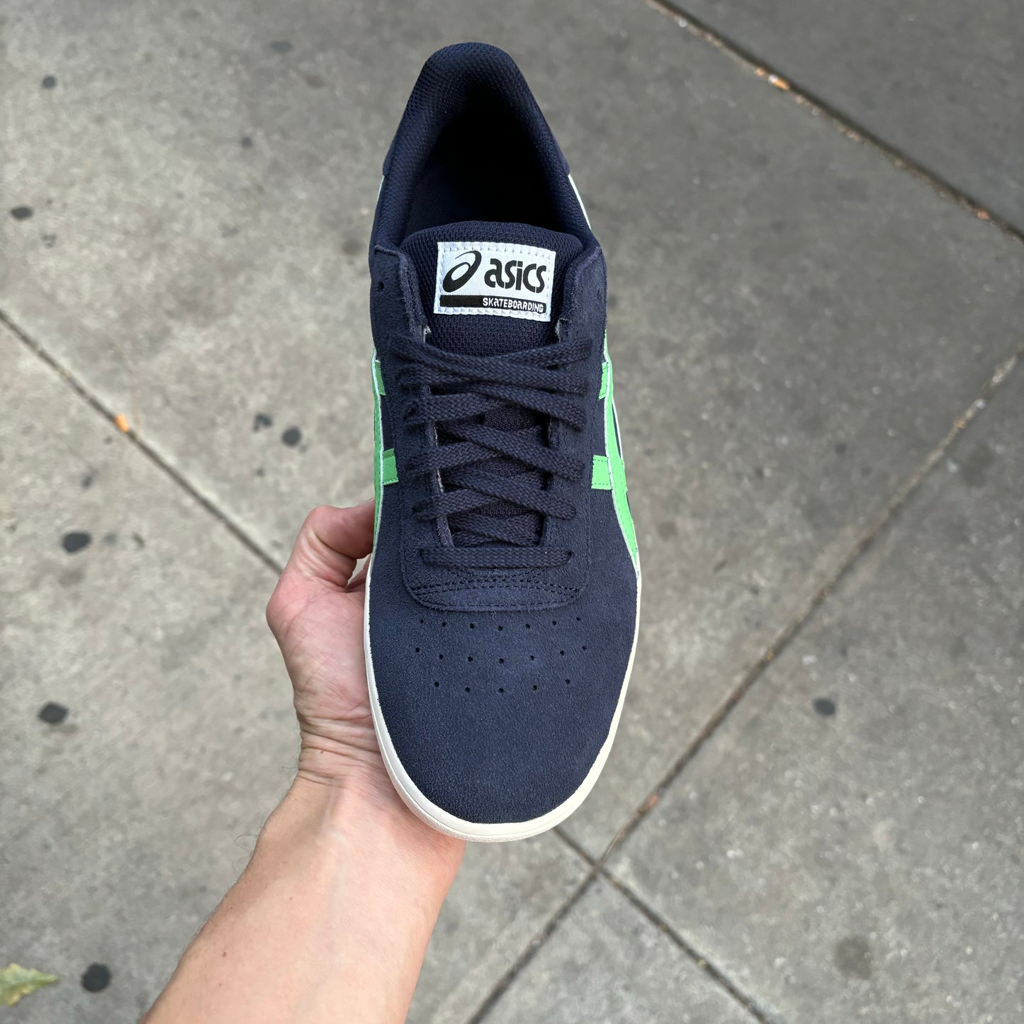 Top down view of navy suede sneaker with white sole