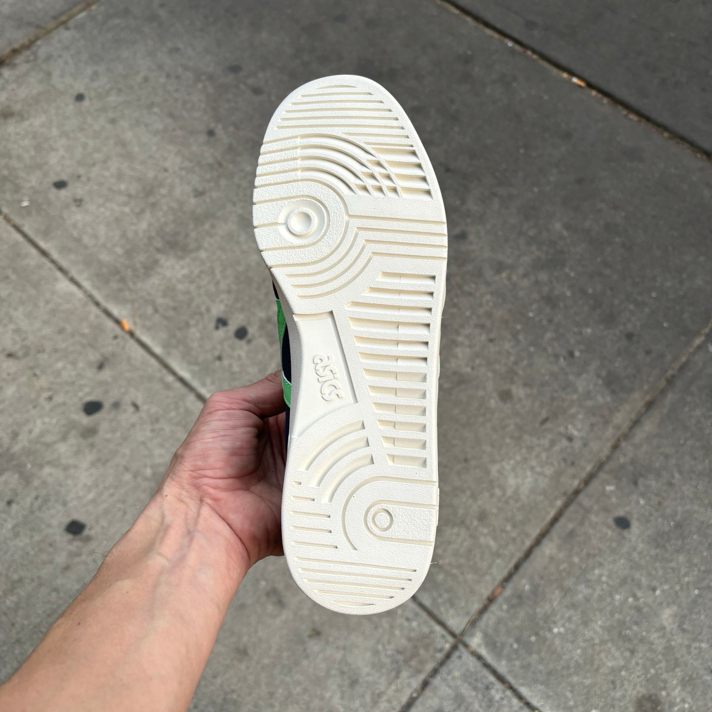 view of white sole on suede skateboard sneaker