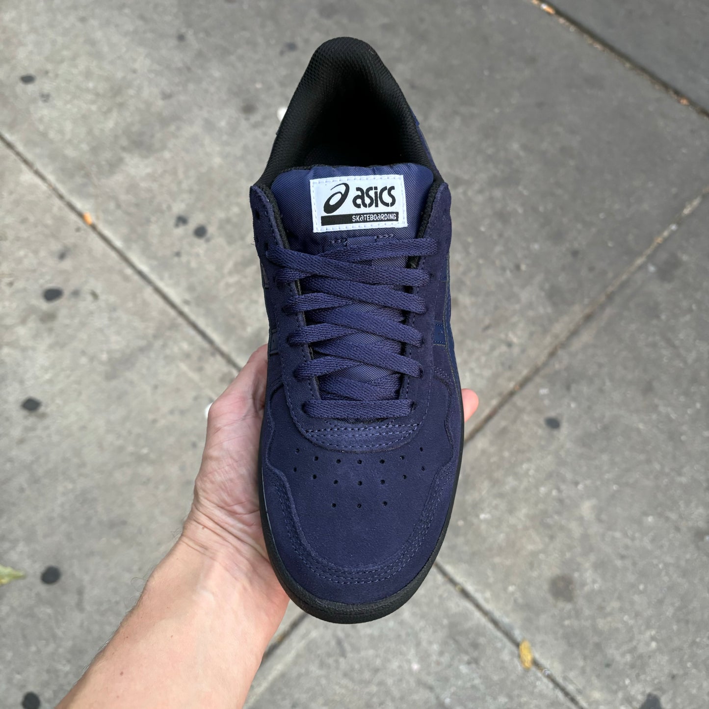 Top down view of navy and black suede skateboard sneaker