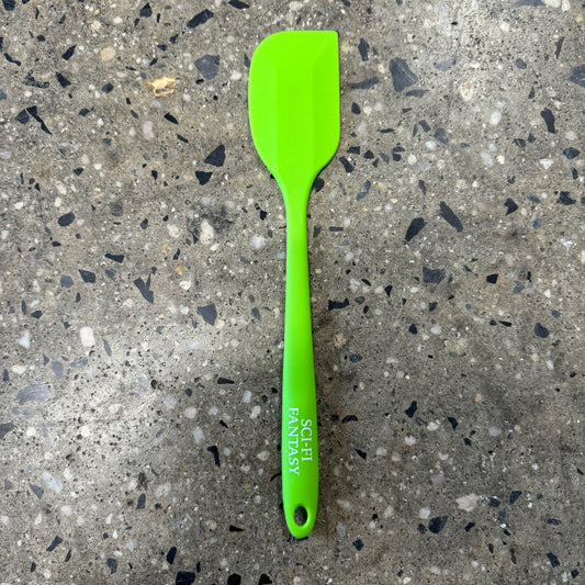 lime green rubber spatula with "sci-fi fantasy" in silver text on the handle