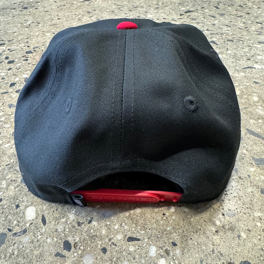 back of the hat. black with red snaps