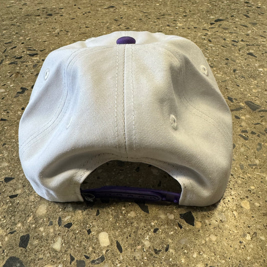 back view of the hat. white with purple snaps