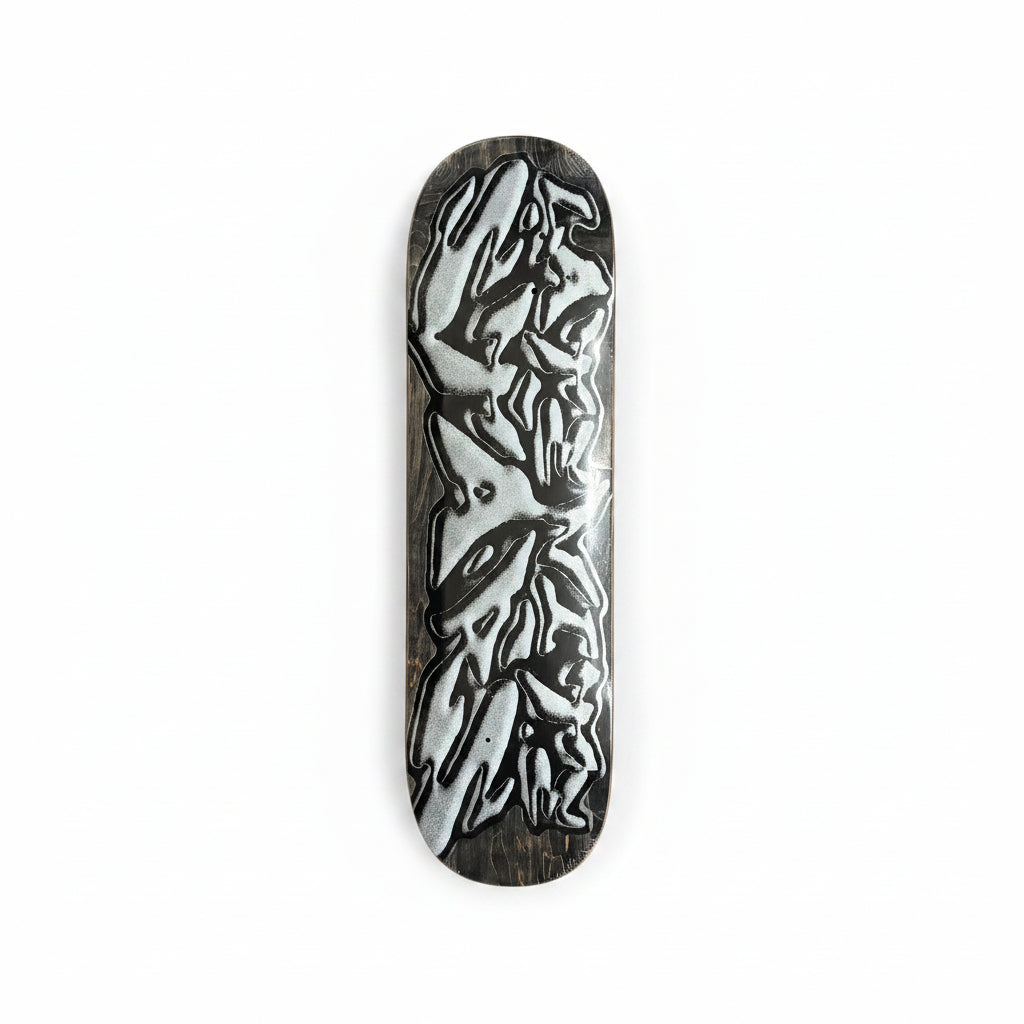 Skateboard deck with a black and white design on a white surface