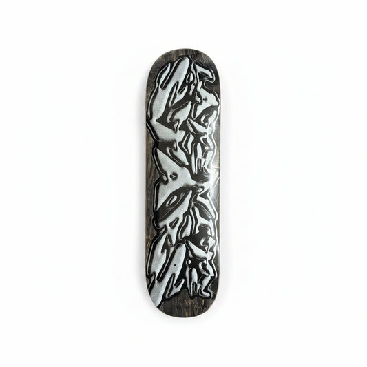 Skateboard deck with a black and white design on a white surface