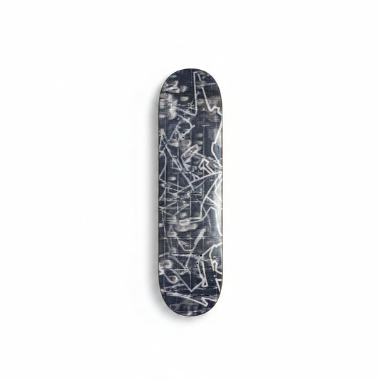 Skateboard deck with abstract design on a white surface