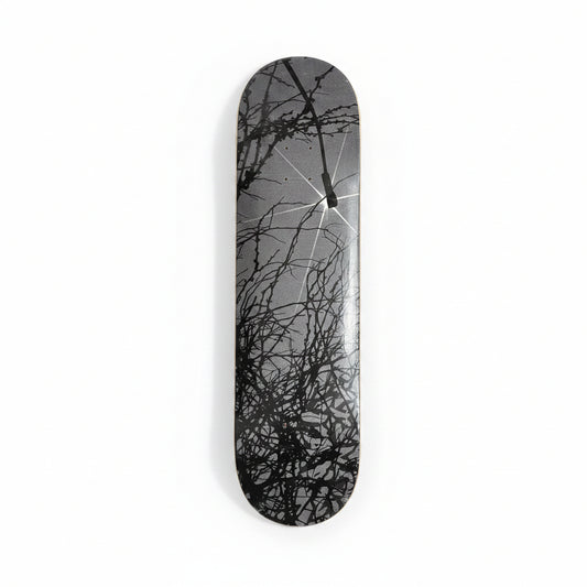 Skateboard deck with black abstract design on a white surface