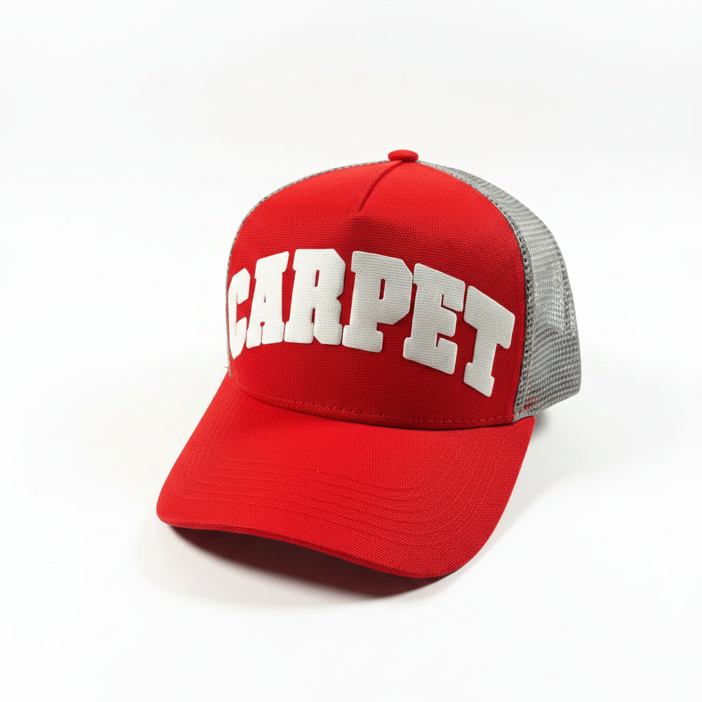 Red cap with 'CARPET' text on a white
 surface