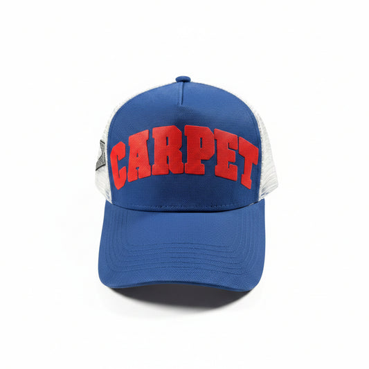 Blue cap with red 'CARPET' text on a white surface
