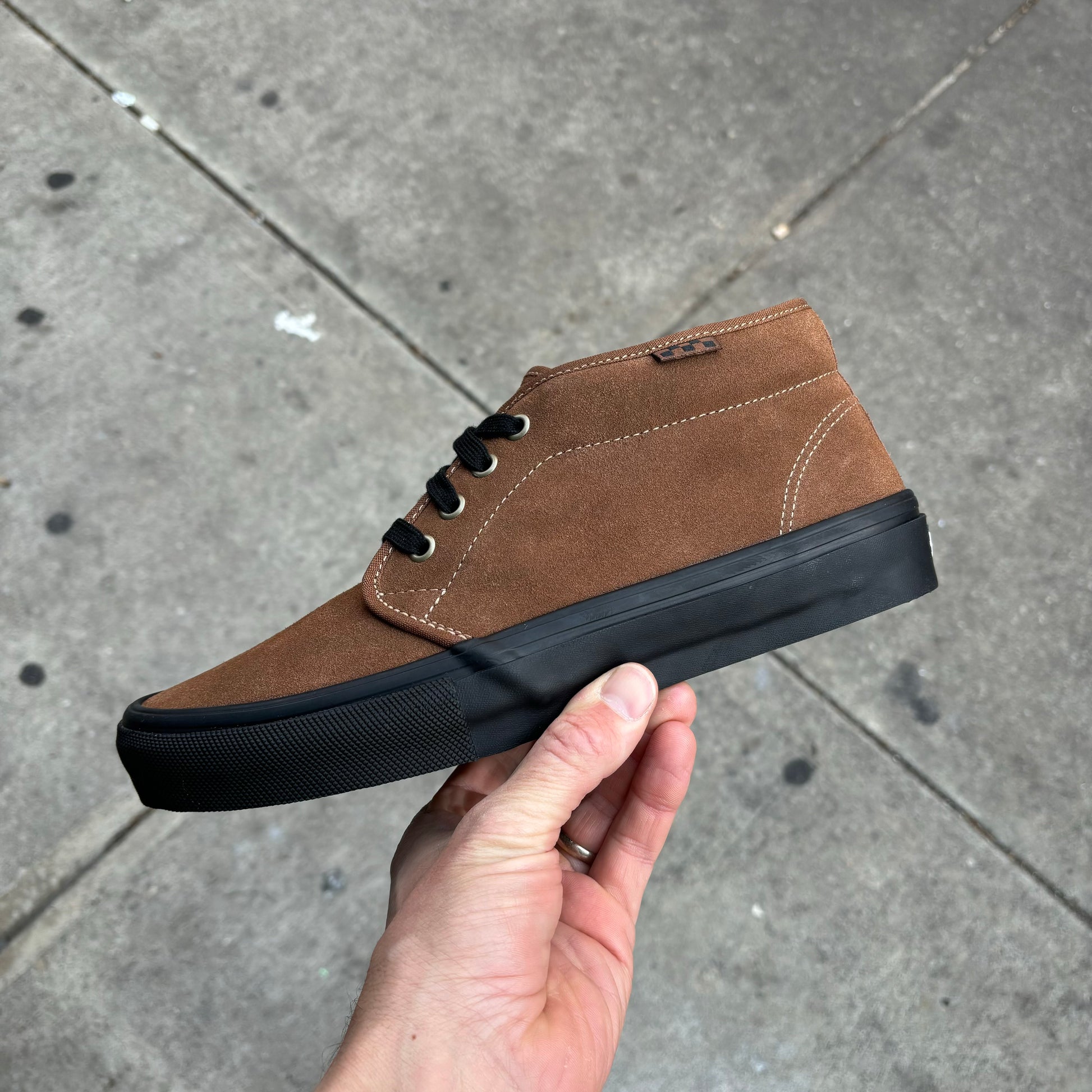 side view of brown suede skateboard sneaker with black sole
