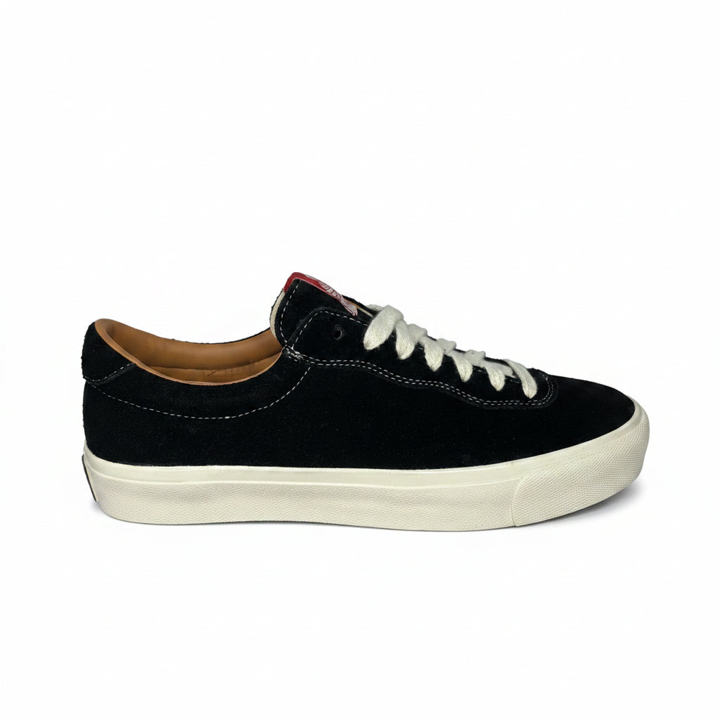 Black sneaker with white laces on a white background