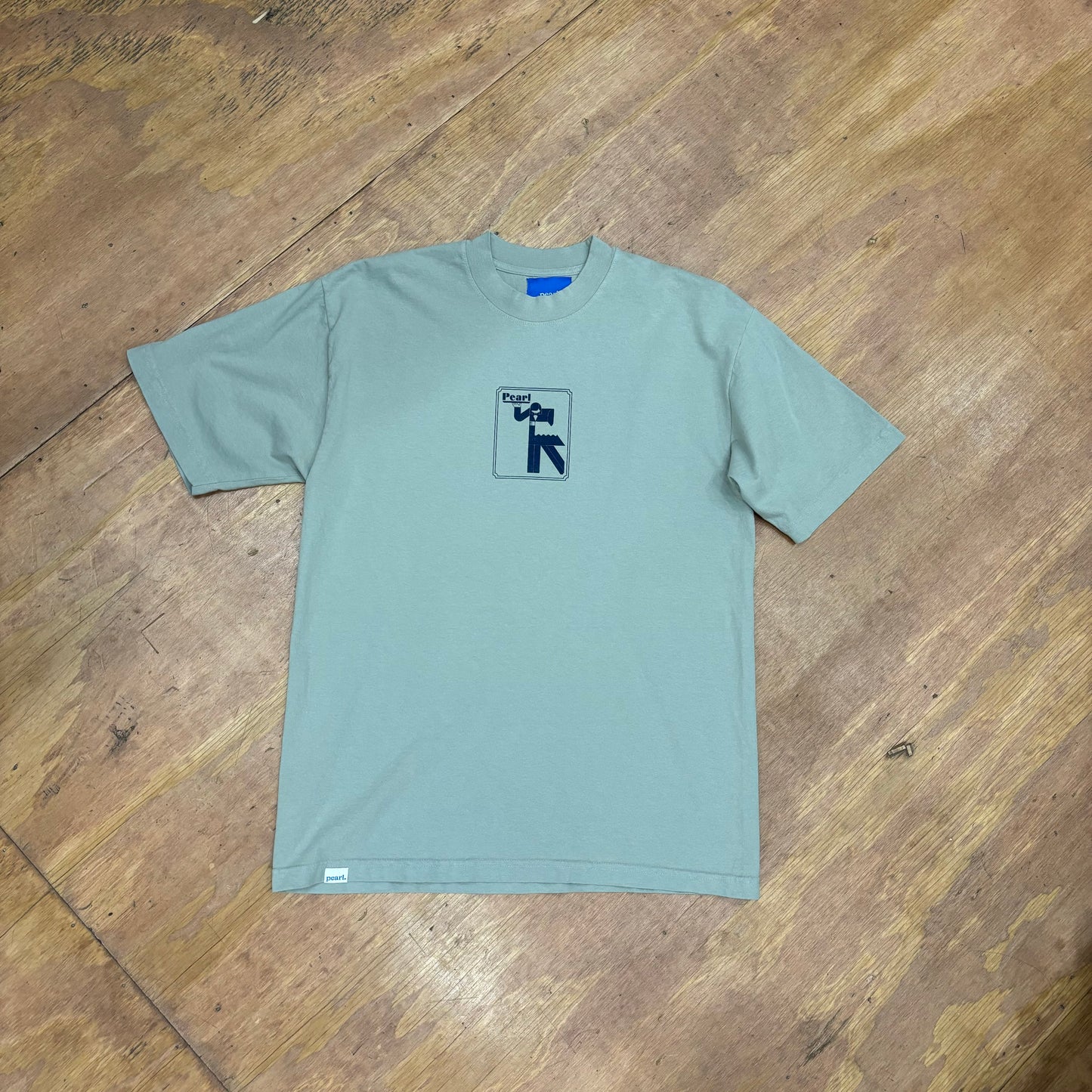 view of sage colored tee with center chest logo