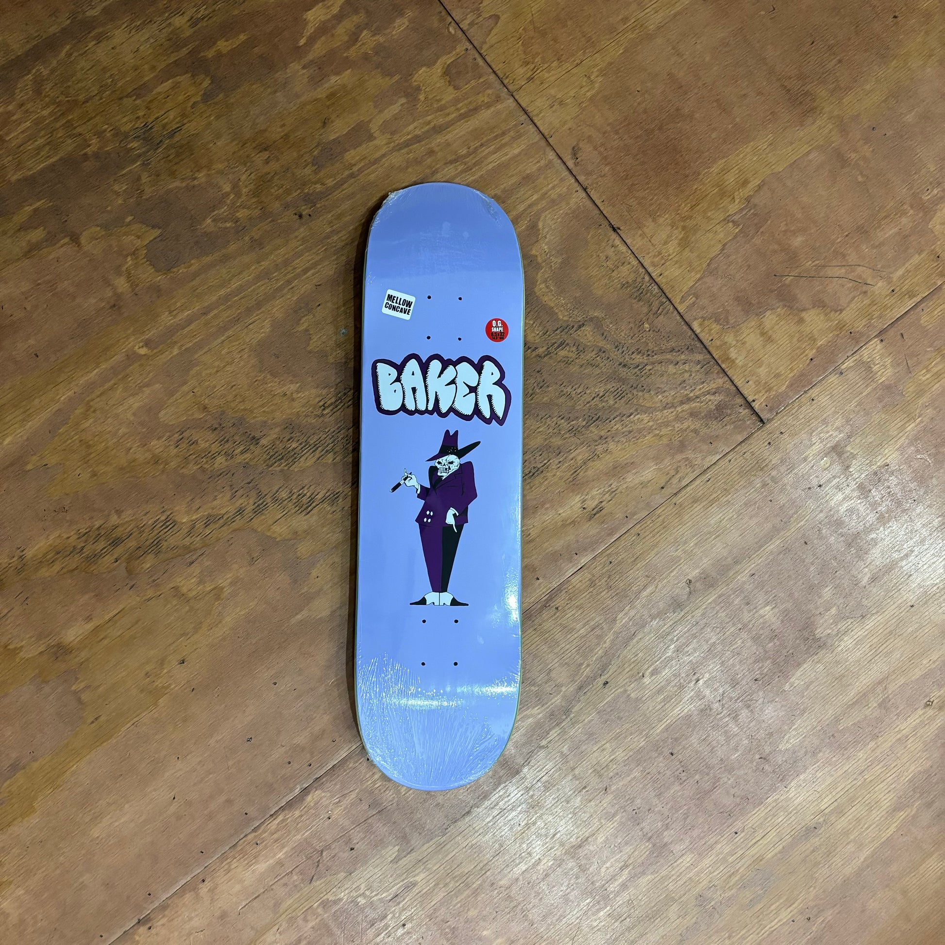 purple skateboard deck with skeleton pimp like man on the middle of the board