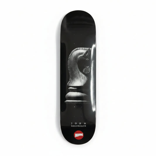 Black skateboard deck with a design on a white surface
