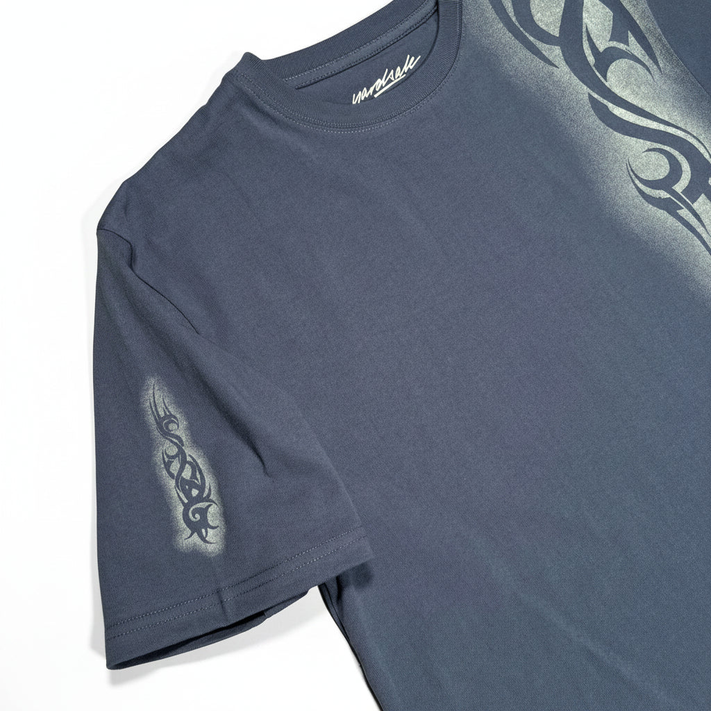 Blue t-shirt with tribal designs on a white surface