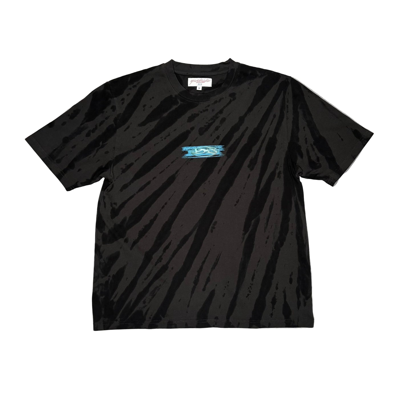 Black t-shirt with light tie dye pattern, and a small center chest logo on a white surface
