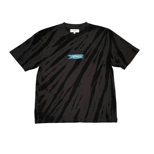Black t-shirt with light tie dye pattern, and a small center chest logo on a white surface