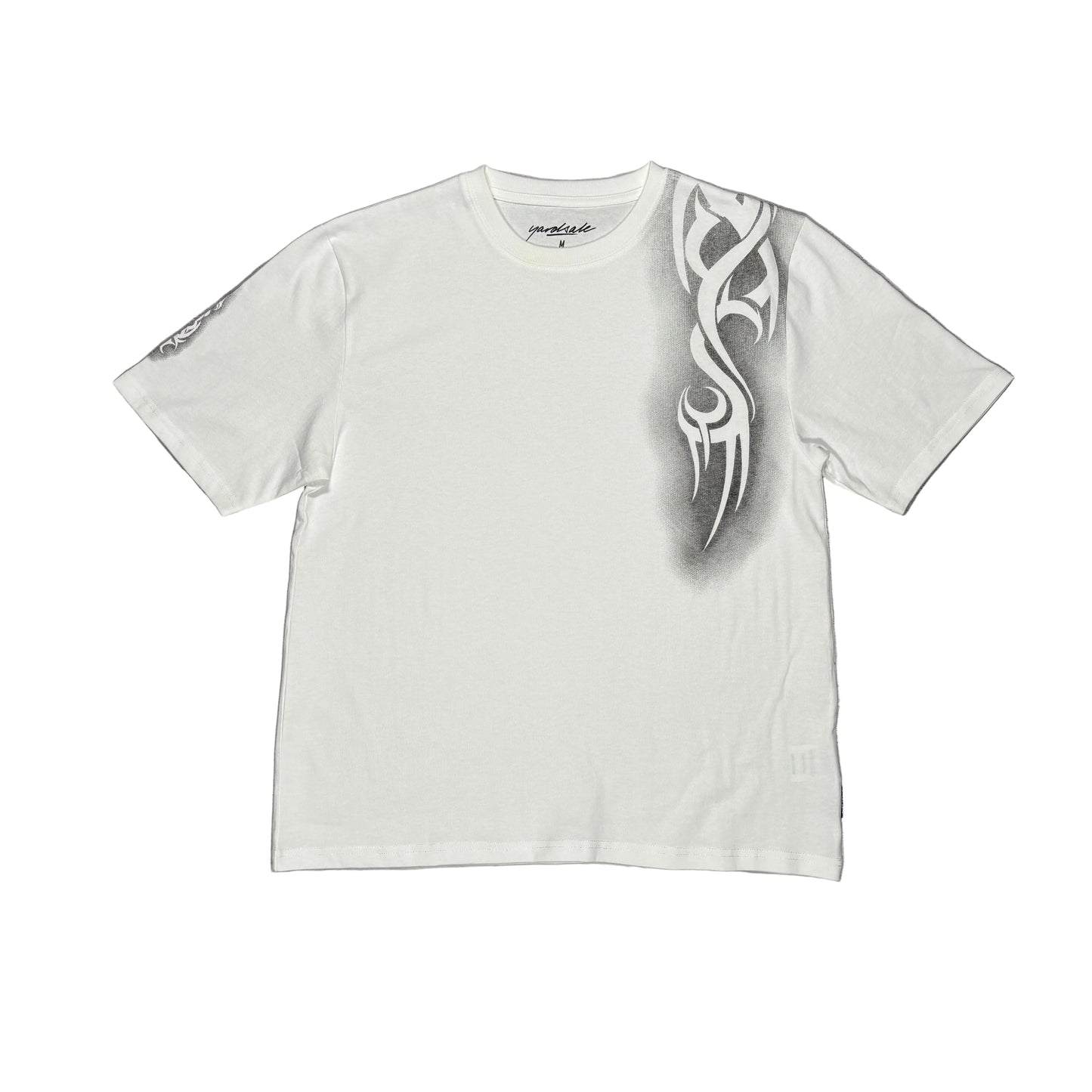 White t-shirt with a tribal design on a white surface