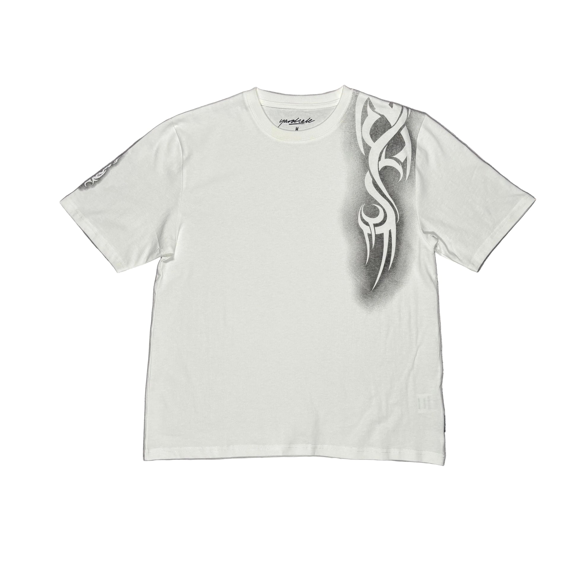White t-shirt with a tribal design on a white surface