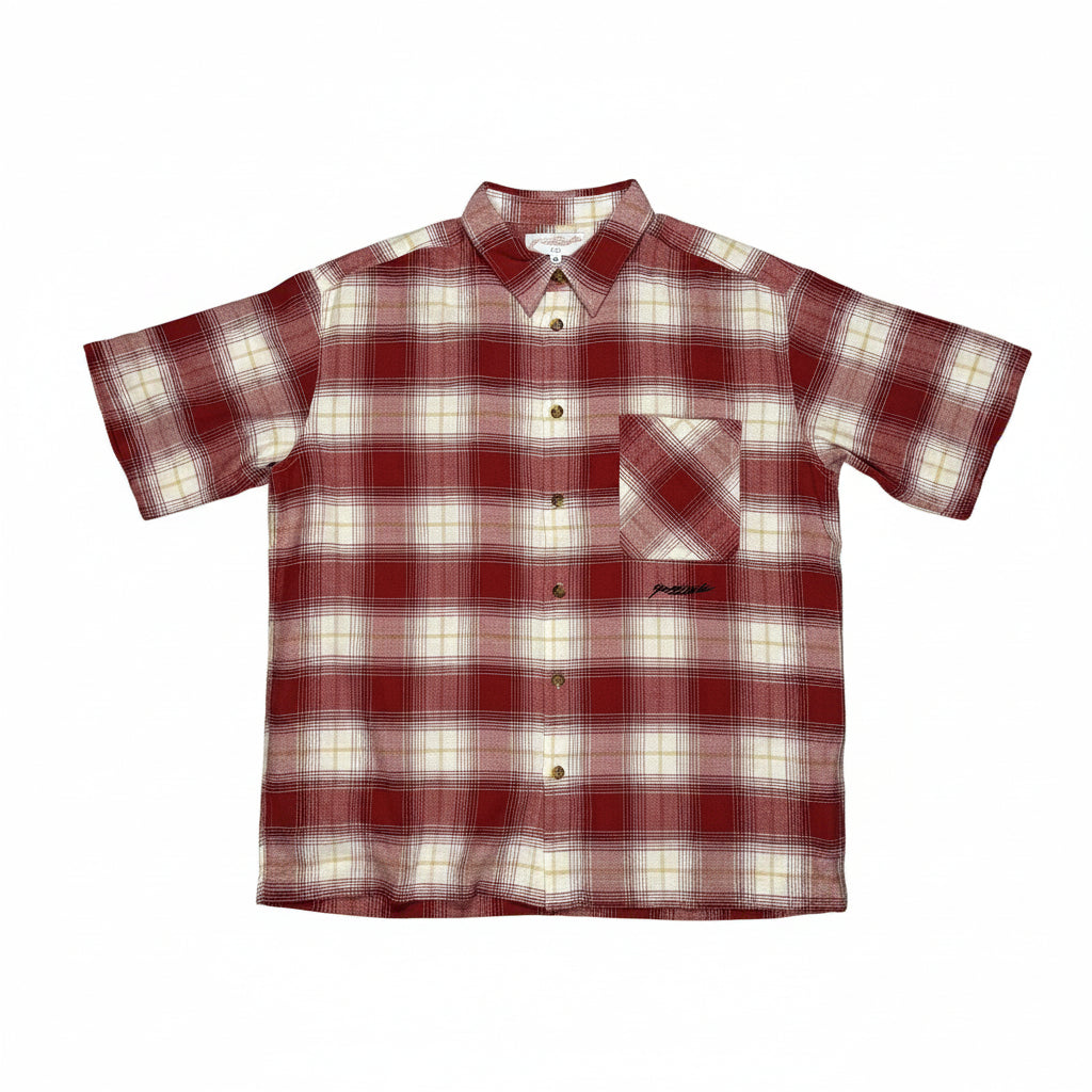 Red and white plaid shirt on a white surface 