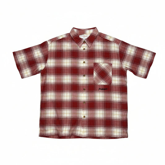 Red and white plaid shirt on a white surface 