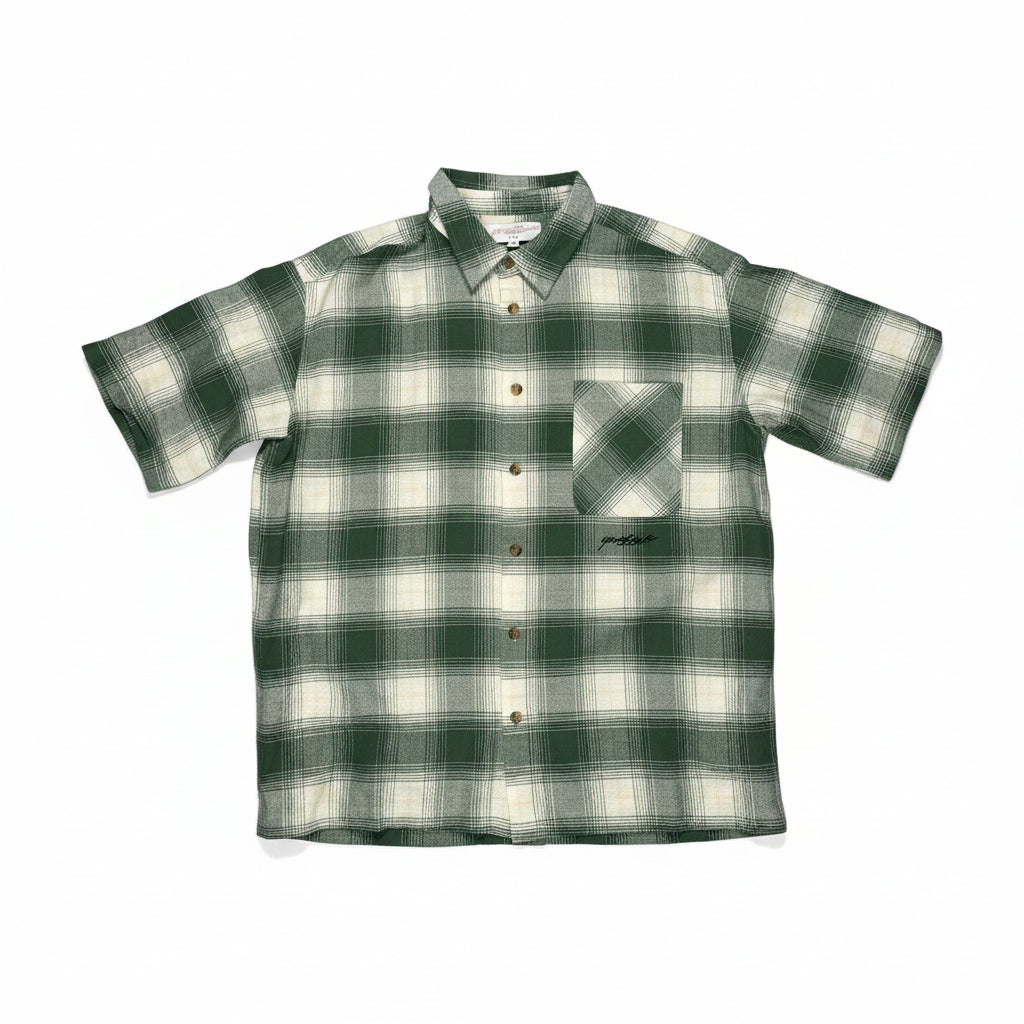 Green and white checkered shirt on a white surface