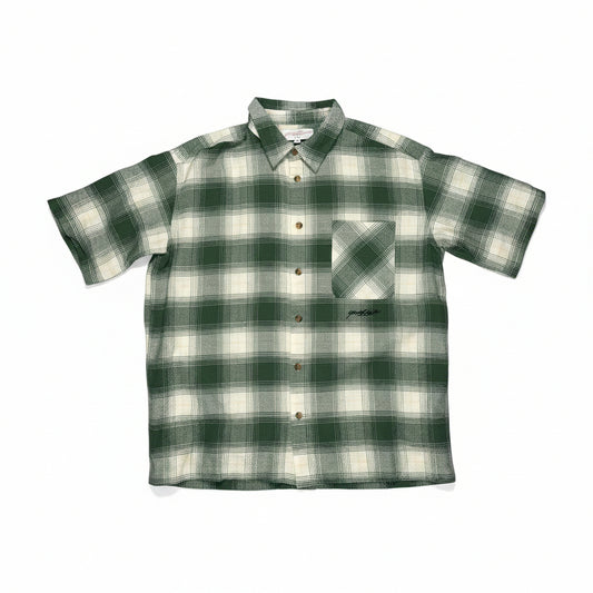 Green and white checkered shirt on a white surface