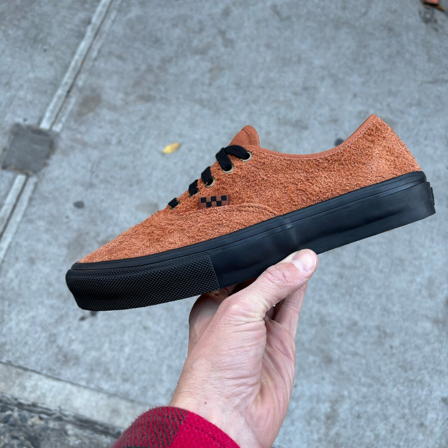 Side view of brown hairy suede low top sneaker with black sole